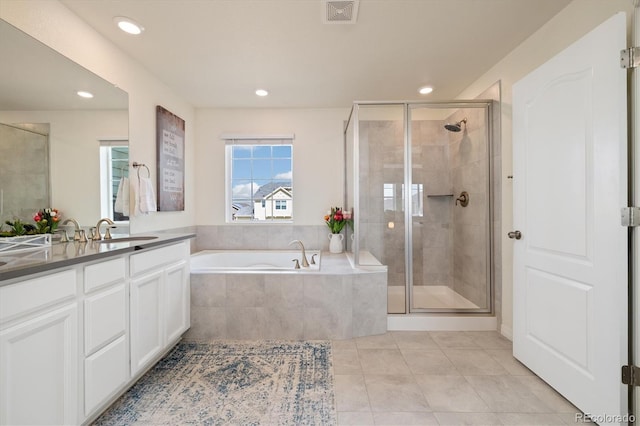 16341 Clayton St, Thornton, CO 80602 - bathroom featuring vanity, tile patterned floors, a garden tub, a stall shower, and recessed lighting
