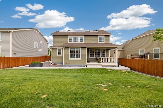 16341 Clayton St, Thornton, CO 80602 - back of property featuring solar panels, a fenced backyard, and a porch