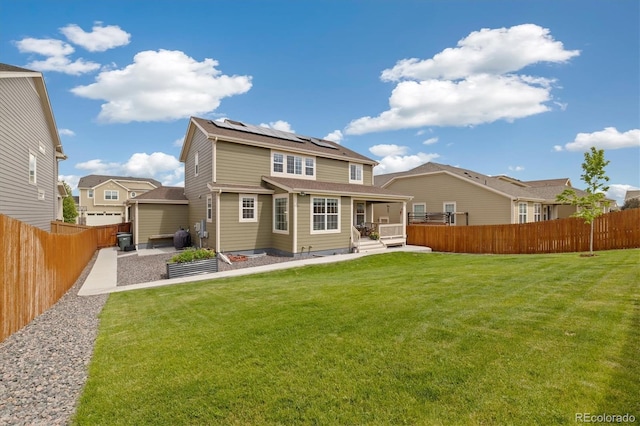16341 Clayton St, Thornton, CO 80602 - back of house with roof mounted solar panels, a fenced backyard, and a patio