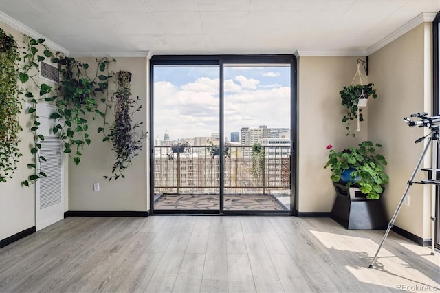 1301 Speer Blvd Unit 1108, Denver, CO 80204 - empty room with a wall of windows, light wood-style floors, crown molding, baseboards, and a view of city