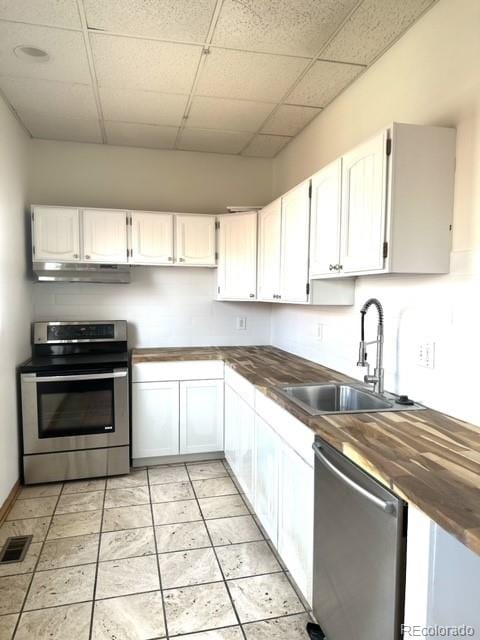 kitchen featuring butcher block counters, white cabinetry, and appliances with stainless steel finishes