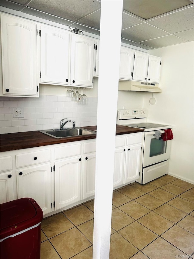 kitchen featuring white cabinets, white electric range, sink, light tile patterned floors, and tasteful backsplash