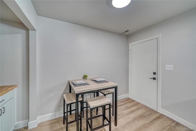 dining space with light hardwood / wood-style floors