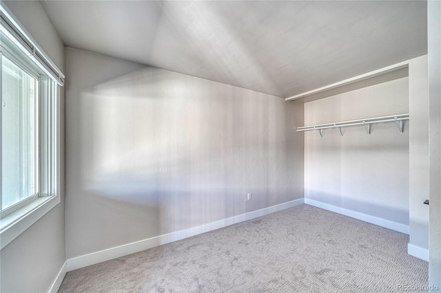 interior space featuring a closet, carpet, and vaulted ceiling