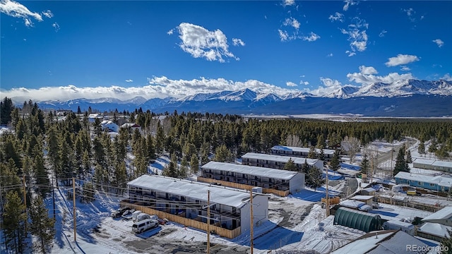 snowy aerial view featuring a mountain view