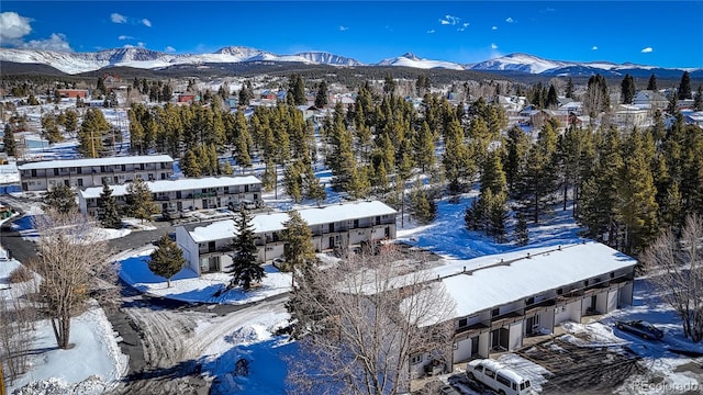 snowy aerial view with a mountain view