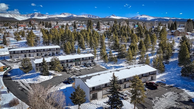 snowy aerial view with a mountain view