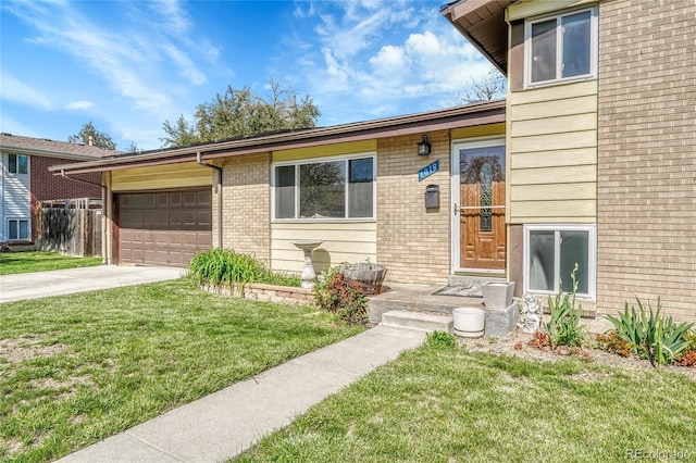 view of front facade with a front lawn, a garage, concrete driveway, and brick siding