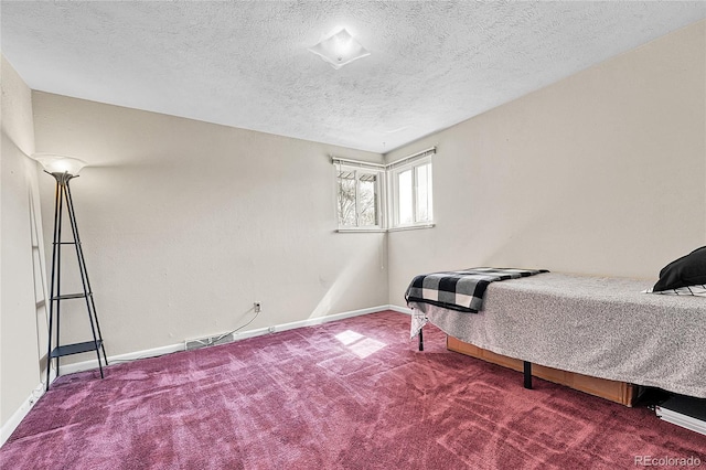 carpeted bedroom with a textured ceiling and baseboards