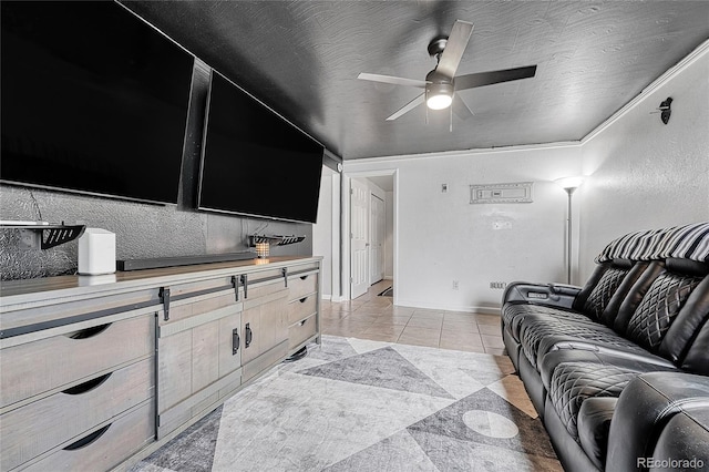 living area featuring ceiling fan, light tile patterned floors, and baseboards