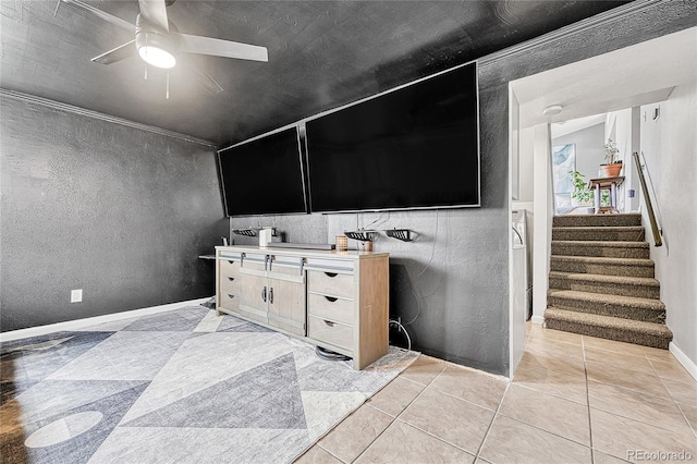 unfurnished living room featuring ceiling fan, stairway, baseboards, and light tile patterned floors