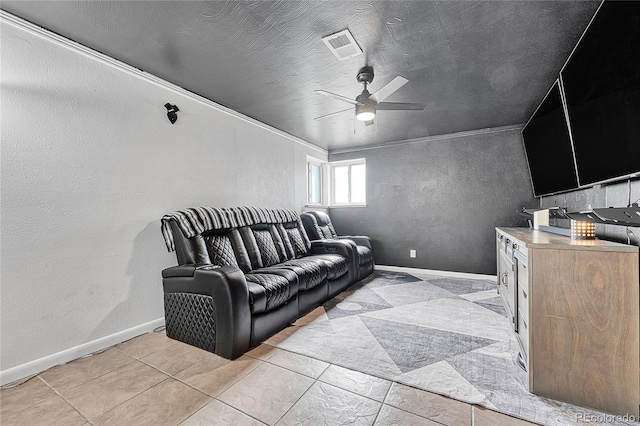 home theater room featuring a ceiling fan, baseboards, light tile patterned floors, and a textured wall