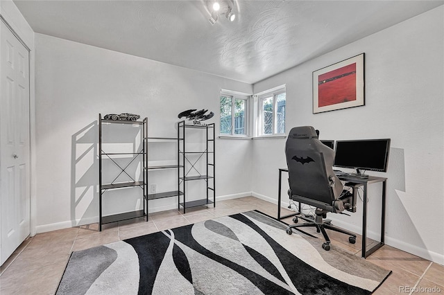 office space featuring tile patterned floors and baseboards