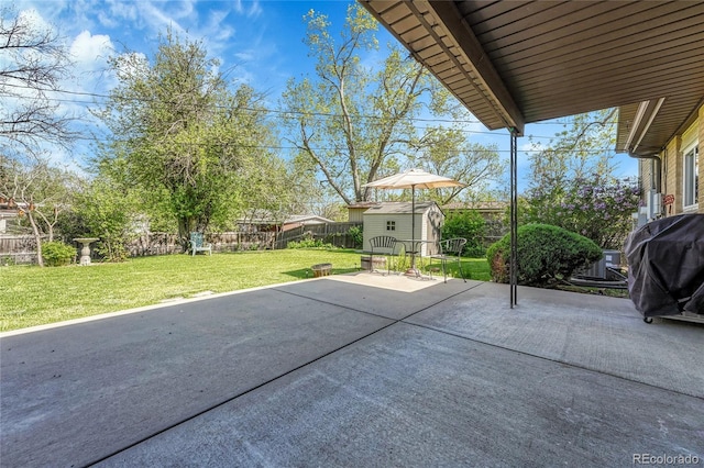 view of patio with a storage shed, an outbuilding, and grilling area