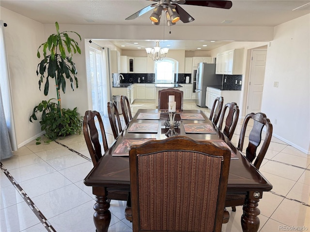 21561 E 48th Pl, Denver, CO 80249 - dining space featuring a ceiling fan, baseboards, light tile patterned floors, and a chandelier