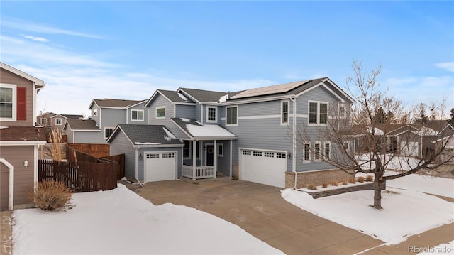 view of front of property with a garage and solar panels