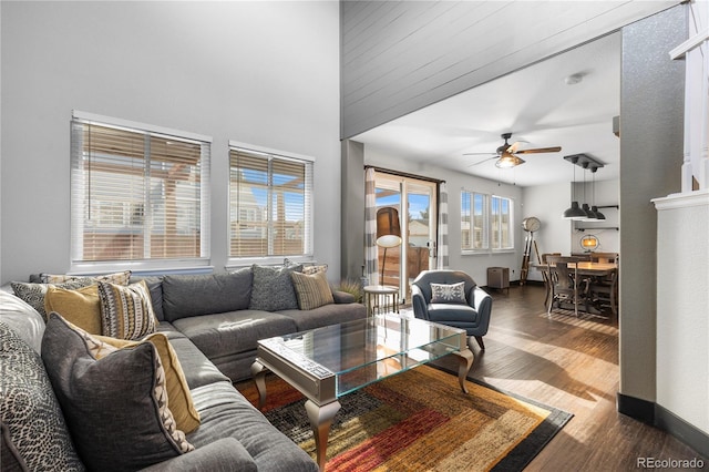 living room featuring ceiling fan and dark hardwood / wood-style floors