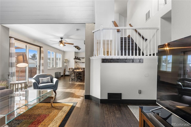 living room with dark hardwood / wood-style floors and ceiling fan