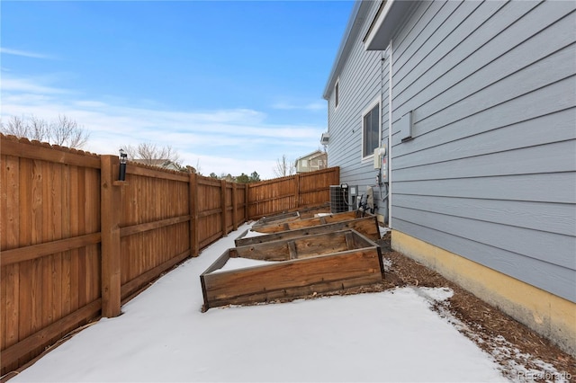 yard covered in snow featuring central AC unit