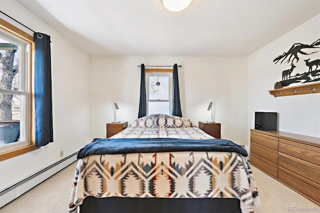 bedroom with multiple windows, carpet, and a baseboard radiator