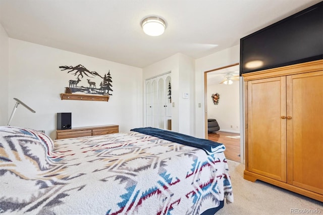 bedroom featuring a closet and light colored carpet