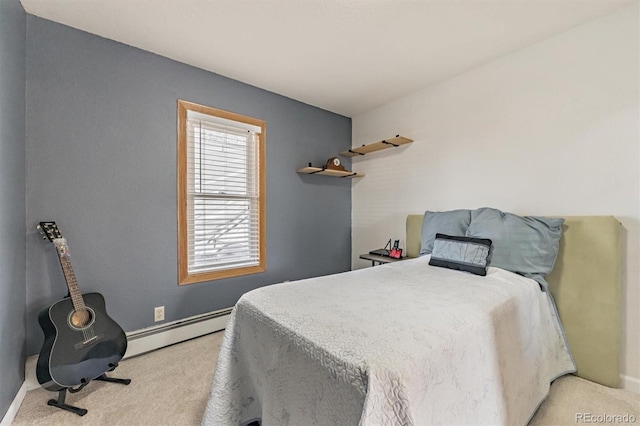 carpeted bedroom with a baseboard heating unit and baseboards