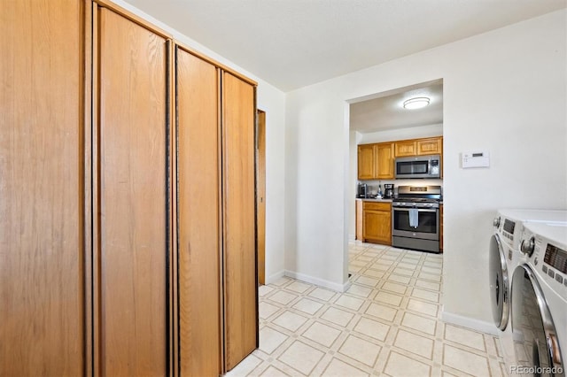 kitchen featuring separate washer and dryer, light floors, appliances with stainless steel finishes, and baseboards