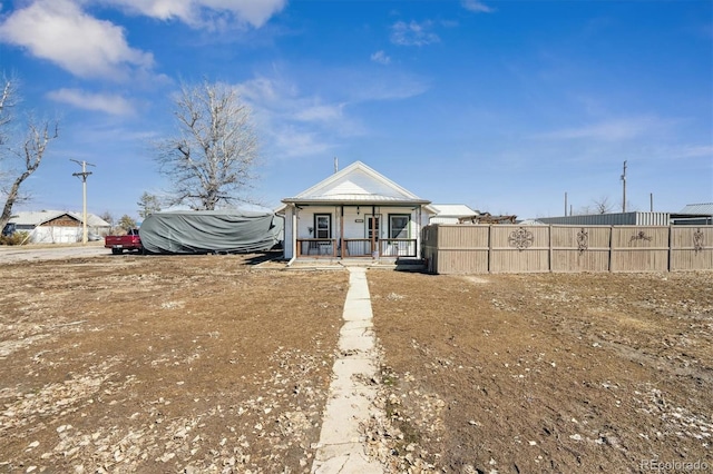 exterior space with covered porch and fence