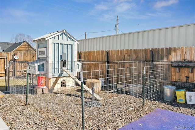 view of outdoor structure featuring an outbuilding and a fenced backyard