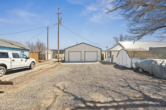 exterior space featuring a detached garage and an outdoor structure