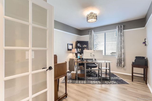 office area with wood finished floors, baseboards, and french doors