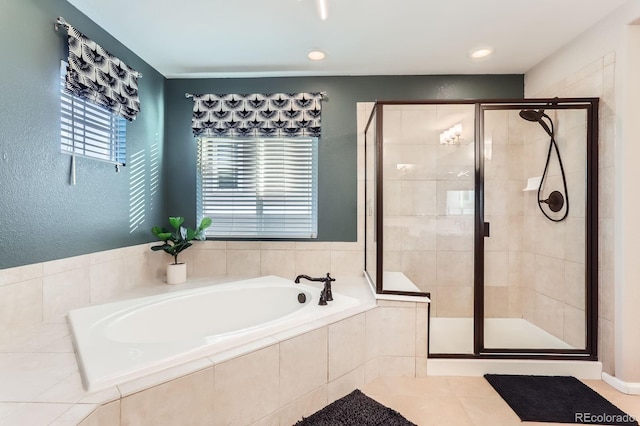 bathroom with a shower stall and a bath
