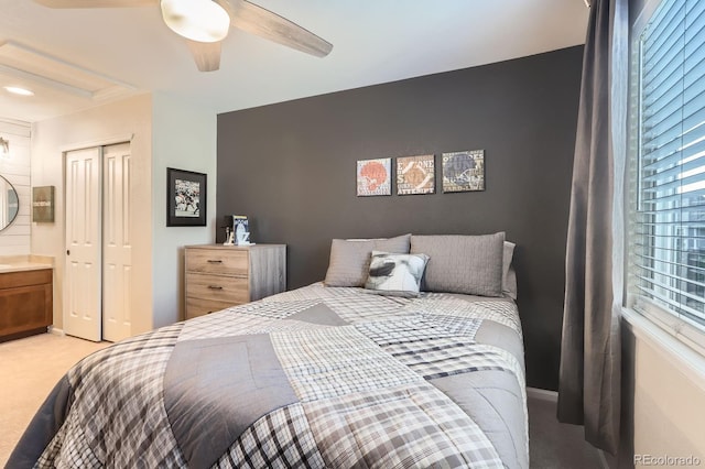 bedroom featuring light carpet, a closet, ceiling fan, and baseboards