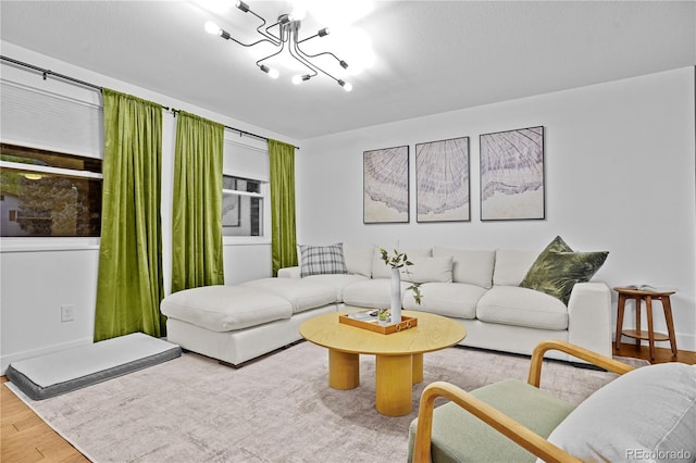 living room featuring hardwood / wood-style flooring and an inviting chandelier