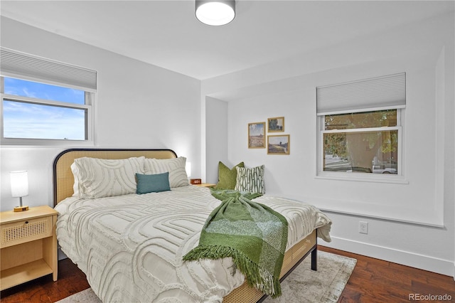 bedroom with dark hardwood / wood-style flooring