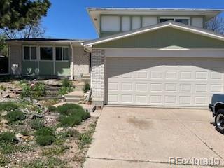 10523 Zuni St, Northglenn, CO 80234 - view of front of house featuring driveway, an attached garage, and brick siding