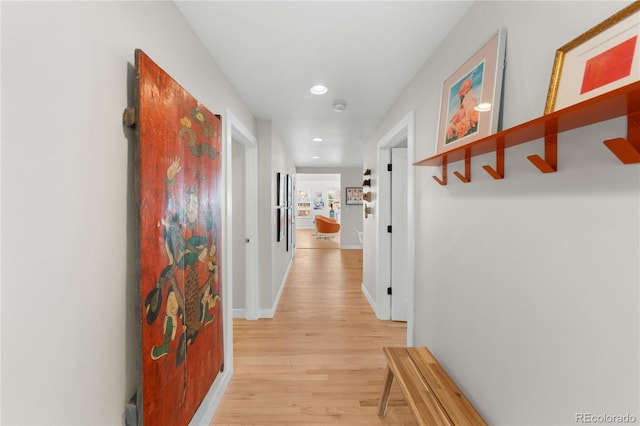 corridor with light hardwood / wood-style floors