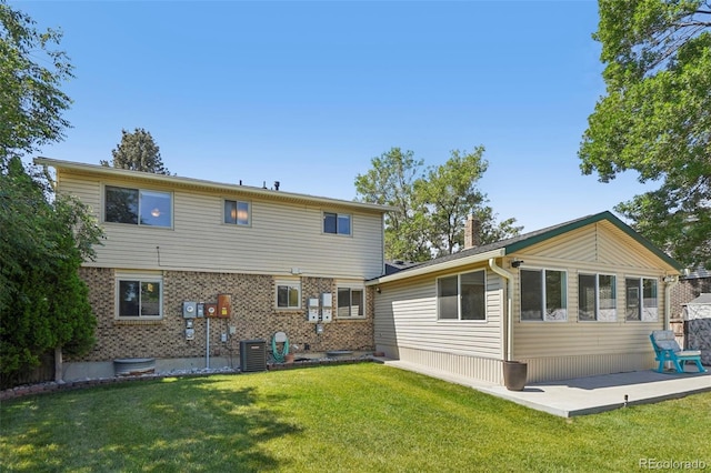 6121 W 108th Ave, Westminster, CO 80020 - back of house with a yard, a chimney, and brick siding