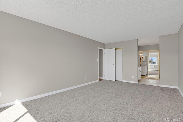 14001 E Marina Dr Unit 603, Aurora, CO 80014 - unfurnished bedroom featuring carpet floors, baseboards, and a textured ceiling