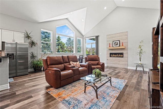 6532 S Tempe St, Aurora, CO 80016 - living area with high vaulted ceiling, a fireplace, wood finished floors, and recessed lighting