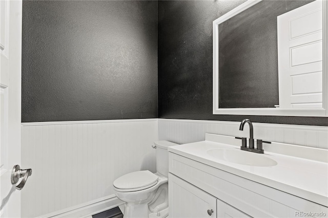 6532 S Tempe St, Aurora, CO 80016 - half bath featuring a wainscoted wall and vanity