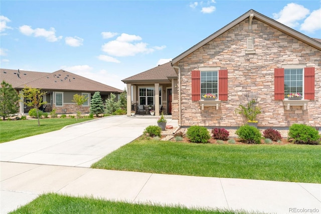 25049 E Alder Dr, Aurora, CO 80016 - view of front of home with stone siding, a front lawn, and driveway