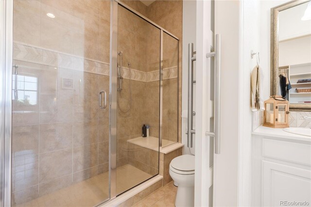 25049 E Alder Dr, Aurora, CO 80016 - bathroom with toilet, a shower stall, tile patterned flooring, and vanity