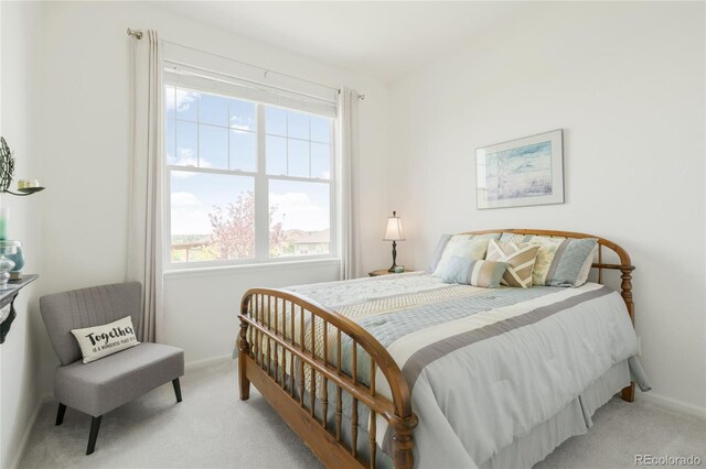 25049 E Alder Dr, Aurora, CO 80016 - bedroom featuring light carpet, multiple windows, and baseboards