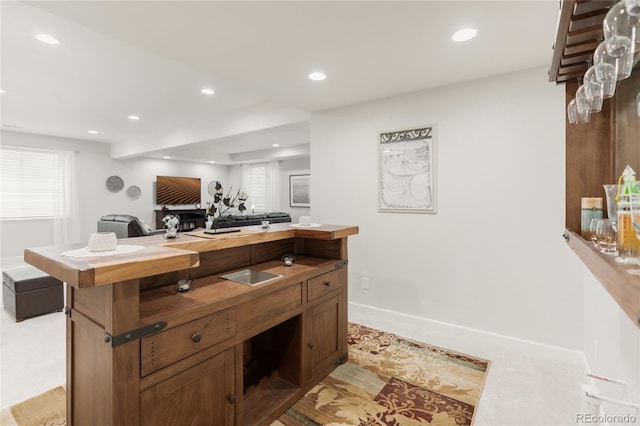 25049 E Alder Dr, Aurora, CO 80016 - kitchen with recessed lighting, an office area, baseboards, light colored carpet, and wooden counters