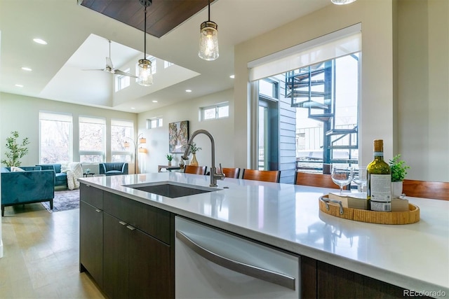 kitchen with dishwasher, hanging light fixtures, a wealth of natural light, and sink