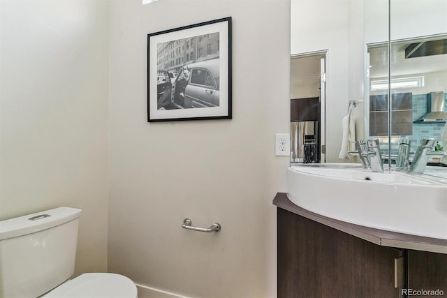 bathroom featuring vanity and toilet