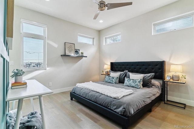 bedroom with ceiling fan and light hardwood / wood-style floors