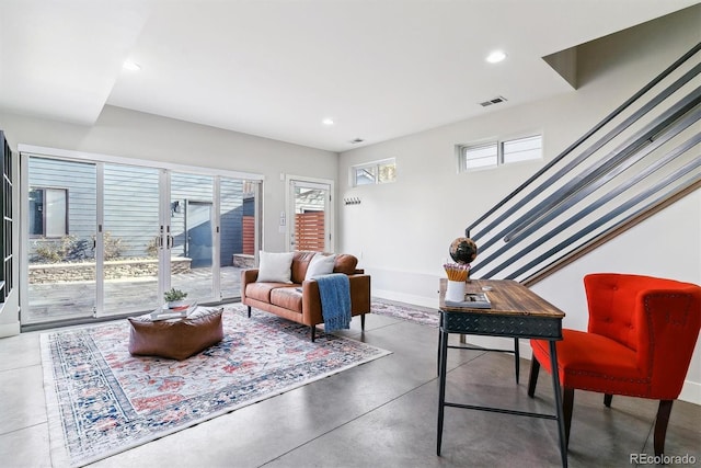 living room with french doors and concrete floors