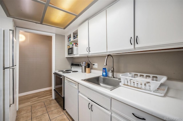 kitchen featuring white appliances, open shelves, a sink, light countertops, and white cabinetry